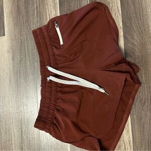 Vuori Women's 4” Clementine Athletic Shorts in Reddish Brown